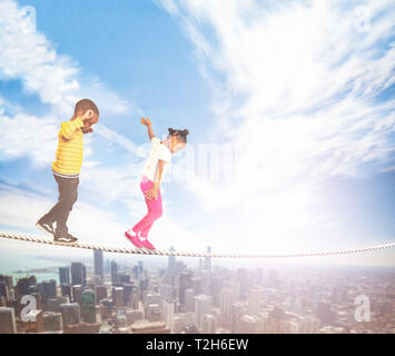 Two kids black boy and girl walking on the rope over city of New York Stock Photo