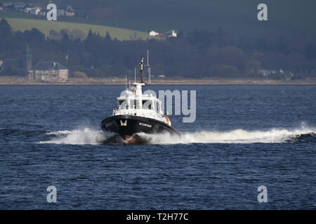 SD Clyde Racer, an Admiralty pilot vessel based on the Firth of Clyde, passing Greenock during the arrival stages of Exercise Joint Warrior 19-1. Stock Photo