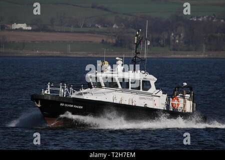 SD Clyde Racer, an Admiralty pilot vessel based on the Firth of Clyde, passing Greenock during the arrival stages of Exercise Joint Warrior 19-1. Stock Photo