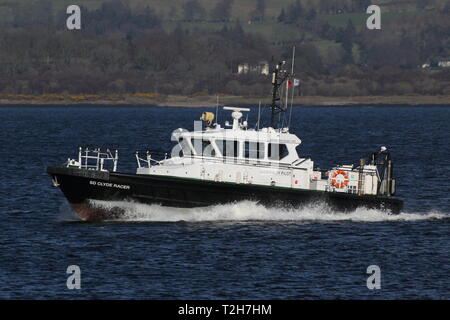 SD Clyde Racer, an Admiralty pilot vessel based on the Firth of Clyde, passing Greenock during the arrival stages of Exercise Joint Warrior 19-1. Stock Photo