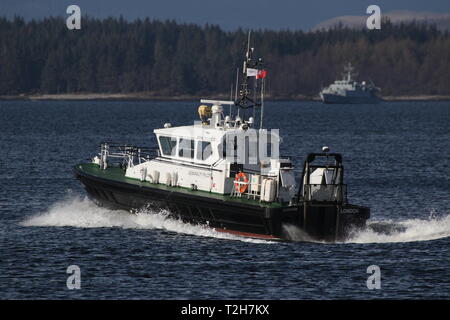 SD Clyde Racer, an Admiralty pilot vessel based on the Firth of Clyde, passing Greenock during the arrival stages of Exercise Joint Warrior 19-1. Stock Photo