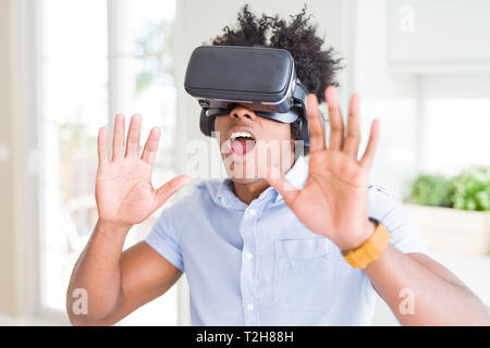African amaerican man having fun playing with virtual reality glasses Stock Photo