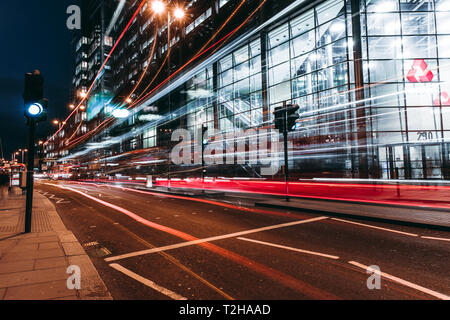 LONDON - MARCH 27, 2019: Traffic light trails on road outside NatWest bank building in City Of London Stock Photo