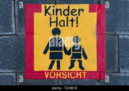 Traffic signs on a pavement, Beware of children, Bavaria, Germany Stock Photo