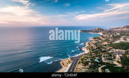 Coastline sunset views from the air during a beautiful cloudy day with sea below the horizon. Stock Photo