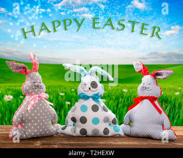Three Easter bunnies and empty space for text. Easter holiday concept. Stock Photo