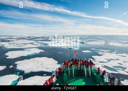 Expedition ship navigating through the pack ice in the Arctic, Svalbard, Norway Stock Photo