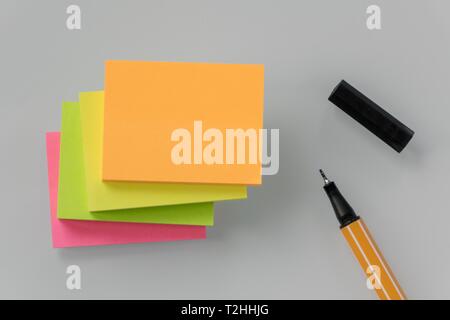 Post it stack, notepad, various colors, and black pen, Germany Stock Photo