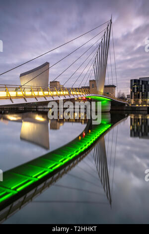 Pedestrian bridge over canal and Imperial War Museum North in Salford Quays, Manchester, England, United Kingdom, Europe Stock Photo