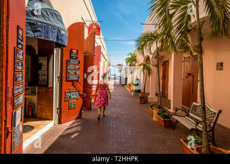 Woman walking by shop in downtown Charlotte Amalie, St. Thomas, US Virgin Islands, Caribbean Stock Photo