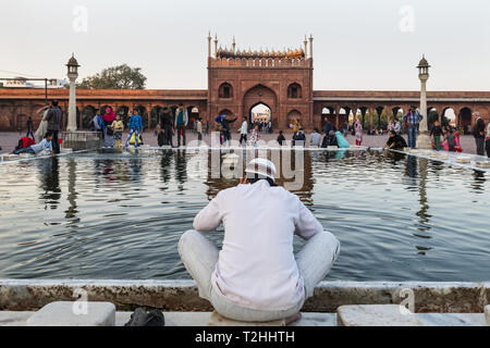 Muslim man washing hands and feet before prayer time, Jama Masjid, one of the largest mosques in India, South Asia Stock Photo