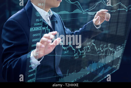 Businessman in front of virtual modern computer virtual touch screen analysing on investment risk management and return on investment analysis Stock Photo