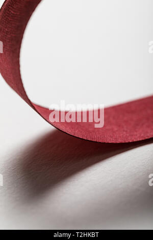 close up of curved satin red ribbons on red background Stock Photo by  LightFieldStudios