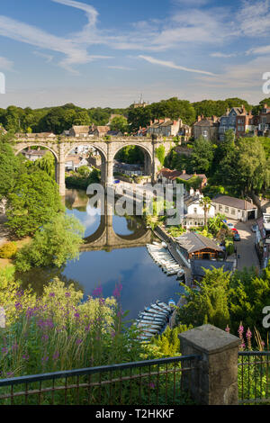 Rowing boats and viaduct over the River Nidd in lower Nidderdale on a mid-summer sunny day, Knaresborough, Borough of Harrogate, North Yorkshire, UK Stock Photo