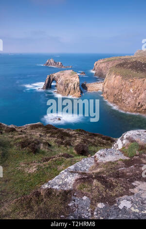 Dramatic cliffs, sea stacks and Enys Dodnan arch on the rugged north Atlantic coast, Lands End, Cornwall, UK Stock Photo