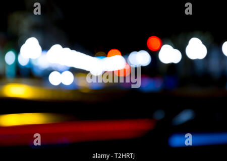 abstract traffic lights on urban street at night, abstract bokeh, blurred motion Stock Photo