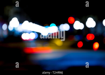 abstract traffic lights on urban street at night, abstract bokeh, blurred motion Stock Photo