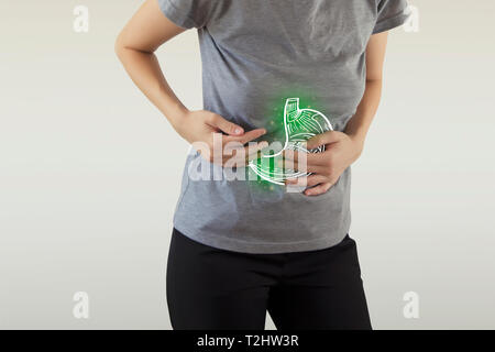 Digital composite of highlighted green  stomach of woman with infection Stock Photo