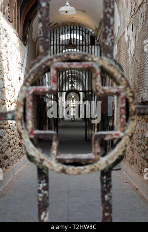 View Through Medical Cross Symbol in the Bars of an Abandoned Prison Hospital Cell Block at Eastern State Penitentiary Stock Photo