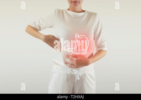 Digital composite of highlighted red pain  stomach of woman Stock Photo