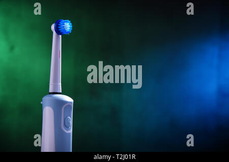 Modern electric toothbrush powered by rechargeable battery. Stock Photo