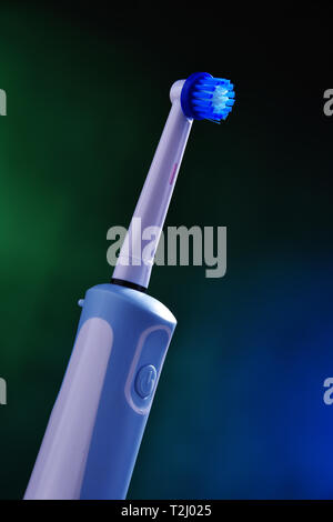 Modern electric toothbrush powered by rechargeable battery. Stock Photo