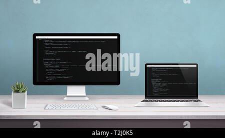 Desktop computer and laptop on work desk with programming editor on display. Concept of programming studio. Stock Photo