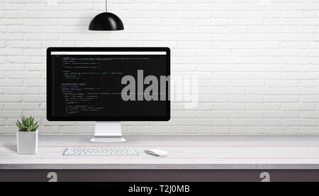 Computer programming on computer display with free space on brick wall for text. Stock Photo