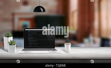 Web development studio concept. Laptop vith script code editor. Copy space beside. Stock Photo