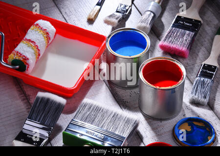 Paint can and paintbrushes of different size  for home decorating purposes. Stock Photo