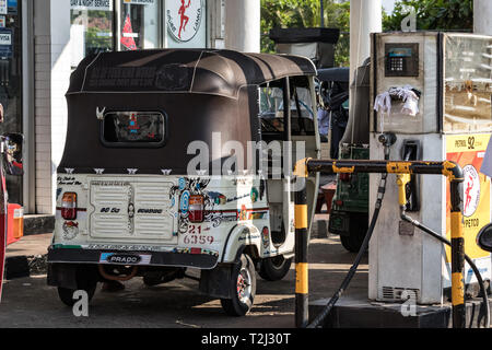 Galle, Sri Lanka - February 18th, 2019: Tuk tuks motorcycle in a queue waiting for gas refueling at a gas station in Galle, Sri Lanka. Stock Photo