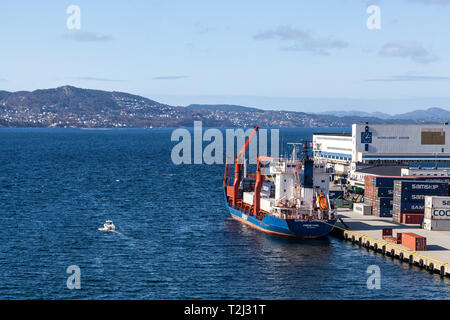 General cargo and container vessel Samskip Commander at work at Dokken terminal (Dokkeskjærskaien), in the port of Bergen, Norway.  View of Damsgaards Stock Photo