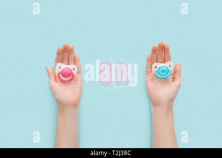 partial view of women holding pacifiers with or lettering Stock Photo