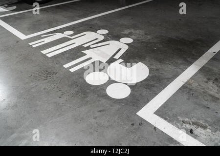 Parking lot with family icon painted on concrete floor Stock Photo