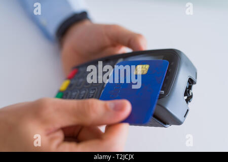 Close up of man hands holding pos terminal Stock Photo