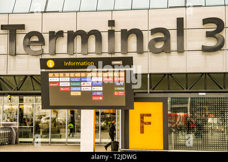 LONDON HEATHROW AIRPORT, ENGLAND - FEBRUARY 2019:  Airline logos showing on an electronic display screen outside London Heathrow Airport Terminal 3 Stock Photo