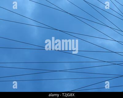 Steel wires of the London Eye form patterns for backgrounds, against a cloudy sky on a rainy afternoon in early April on the South Bank of the capital Stock Photo