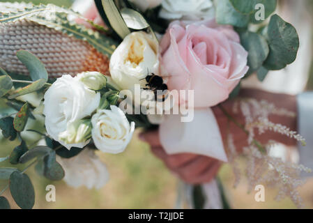 Wedding bridal bouquet in the rustic style on which the bee sits. Stock Photo