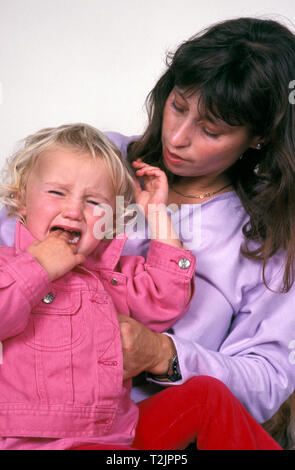 Mother consoling crying toddler Stock Photo