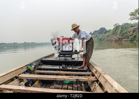 River boatman transporting goods and people on the Myitnge River, near Inn Wa, Sagaing Region, Myanmar (Burma) Stock Photo