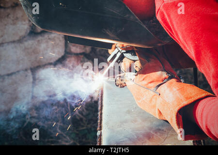 a welder puts the seam on the metal electro arc welding Stock Photo