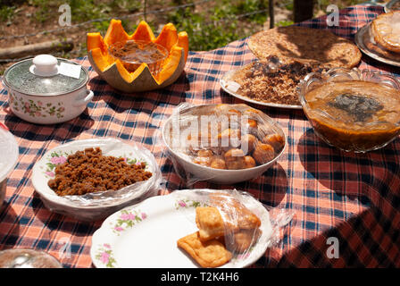Diffrent colored dishes of local traditional foods put on the simple wooden table Stock Photo