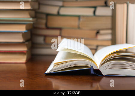 open book on the table against the background of books Stock Photo