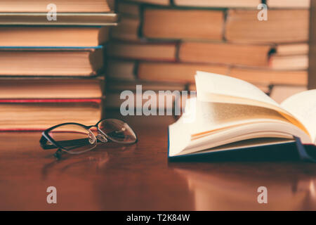 open book on the table against the background of books Stock Photo