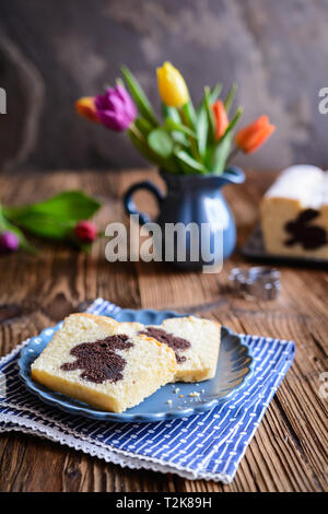 Sweet vanilla pound cake with Easter bunny inside, sprinkled with powdered sugar Stock Photo