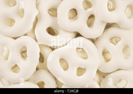 Set of white chocolate covered pretzels. Flatlay as abstract background. Copy space for your text. Stock Photo