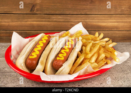 Duo of hot dogs and french fries on table. Fast food restaurant concept. Close up. Copy space for your text. Stock Photo