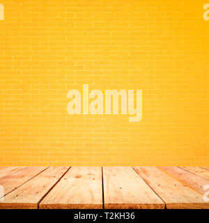 Empty wood table top with yellow brick wall background.For create product display or design key visual layout Stock Photo