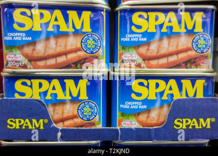 Stacked tins of unopened Hormel Foods Spam on a supermarket shelf. Stock Photo