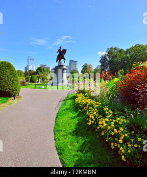 Boston Public Garden, summer and fall grounds landscaping. Washington statue and city skyline in background Stock Photo